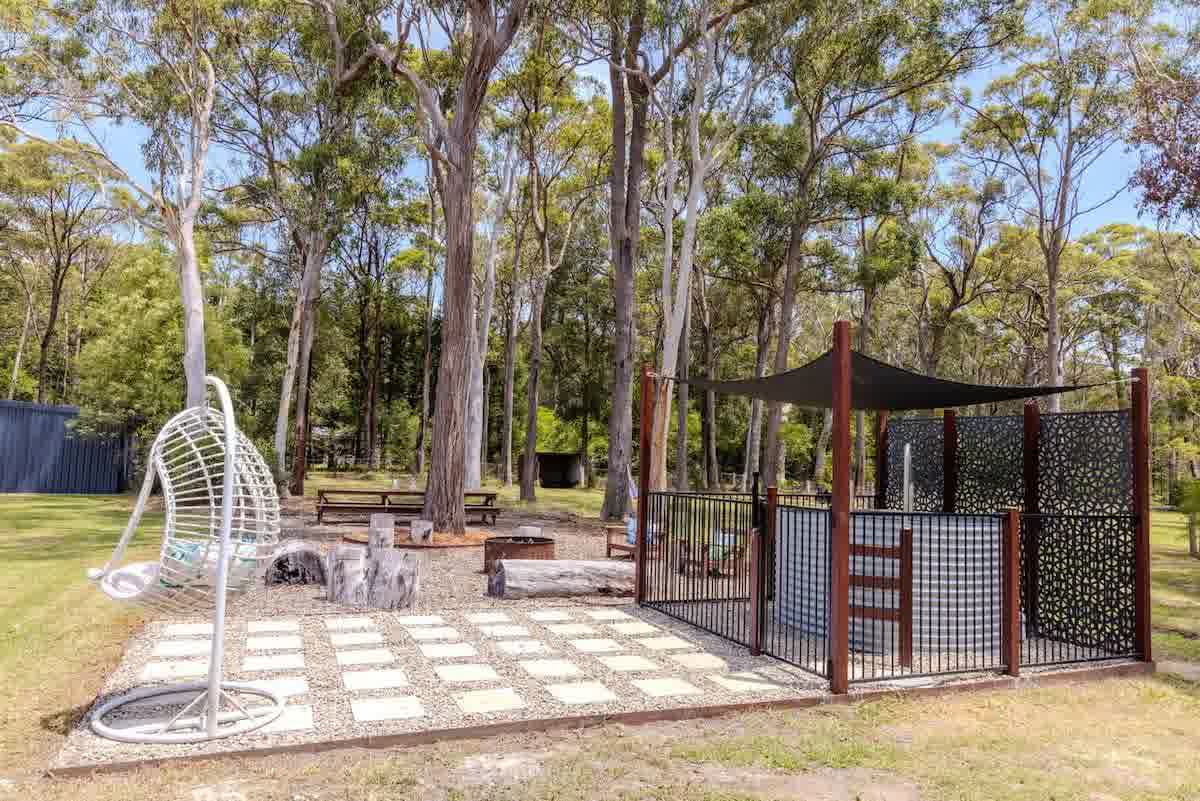 Outdoor entertaining area with seating and gardens at farm retreat
